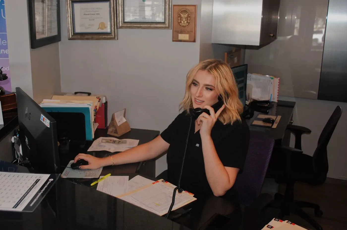 Team member answering the phone at the front desk